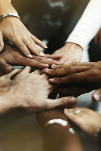 Closeup of diverse people joining their hands